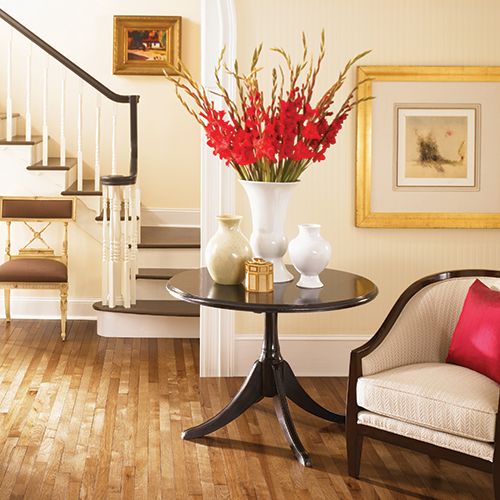 Beautiful light honey hardwood floors in foyer with furniture accents