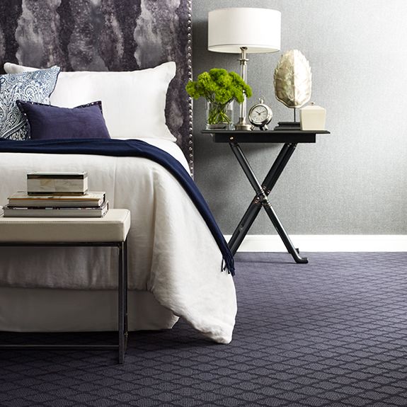 Patterned blue carpet in bedroom