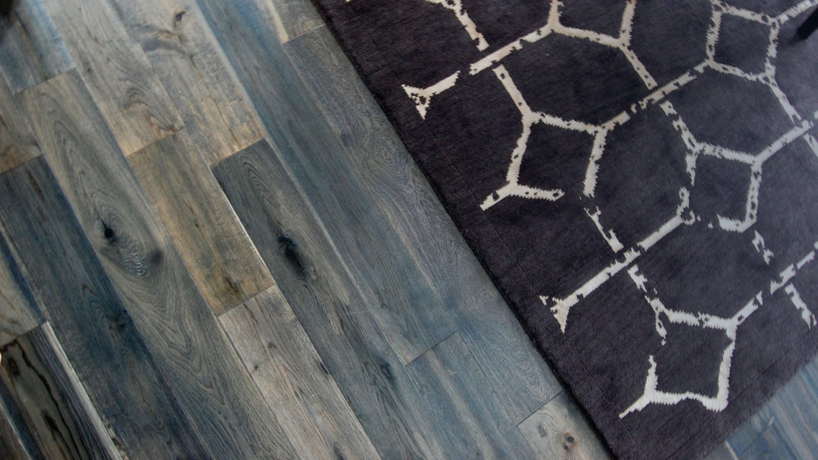 Man sitting on area rug in living room