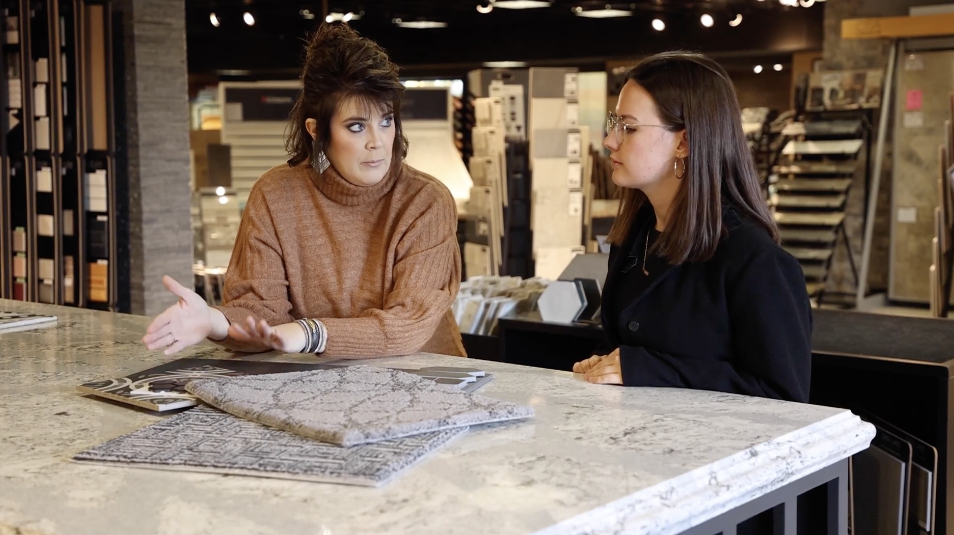Sergenian's employee consulting with customer over carpet samples
