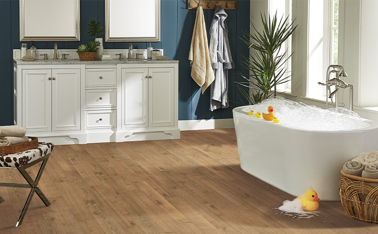 warm toned engineered hardwood flooring in bathroom