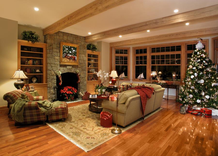 Living room at the holidays, with lights from the tree reflecting off the hardwood floor